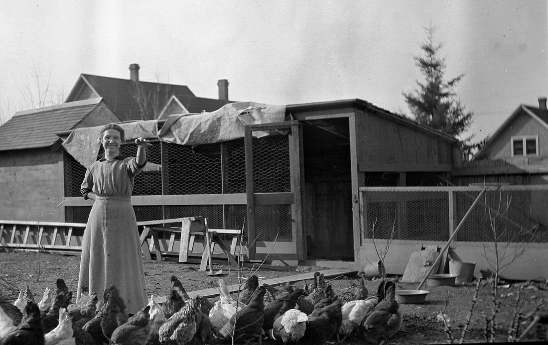 Maria Krieger (née Lind) tends the chickens at her home on NE 10th. Photograph taken by Gottfried Schreiber, a friend of Maria and Henry Krieger. Circa 1915.