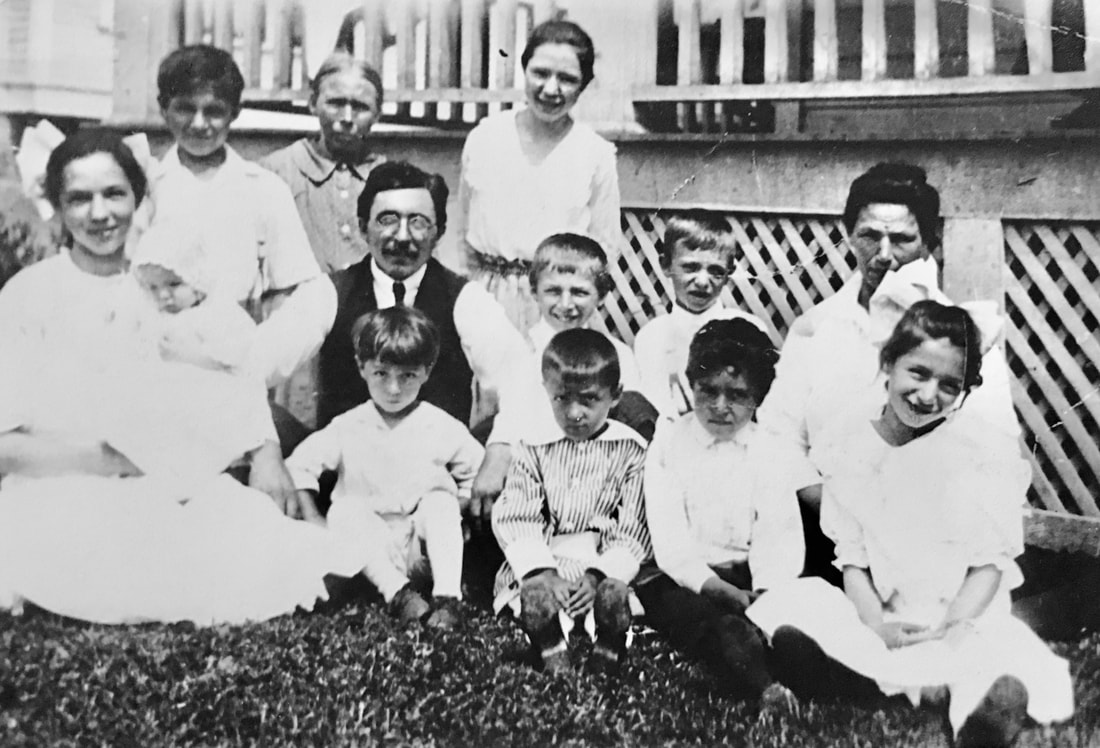 Photograph of the Rueck family in 1917 at their home on NE 10th Street in Portland, Oregon. 