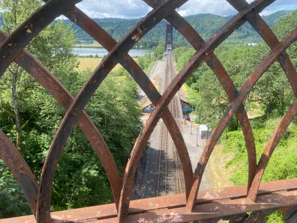 View looking southwest from the Willamette Blvd. bridge over the St. John's cut. The Willamette River rail bridge is shown in the distance.
