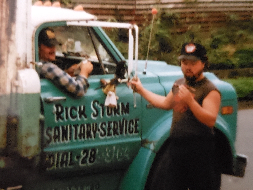Photo Rick Sturm Sanitary truck. Standing outside the truck is Teddy Sturm, brother of Rick Sturm. The business was originally started by their father. Photo courtesy of Greg Sturm.